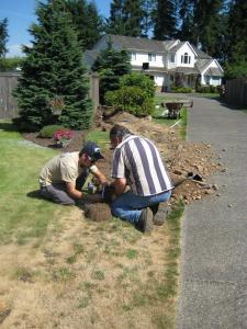 two of our Pompano Beach sprinkler repair contractors are fixing a broken line